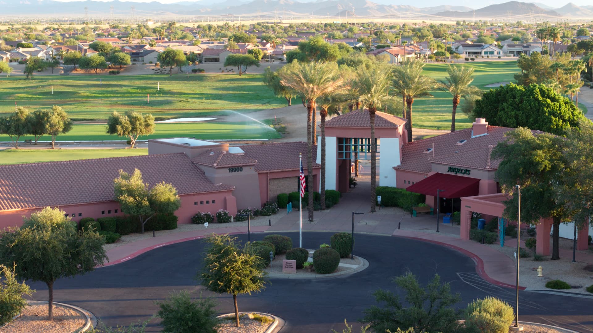 Golf clubhouse, palm trees and fairways at The Grand in Surprise, Arizona