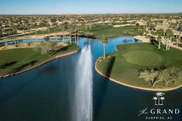 Aerial view of a lake fountain and green at a golf course in The Grand in Surprise, Arizona